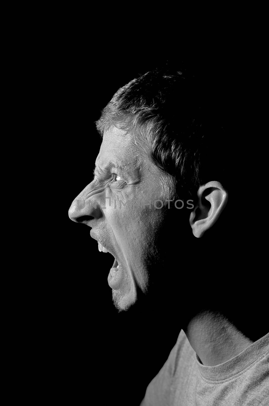 Young caucasian man screaming by anderm