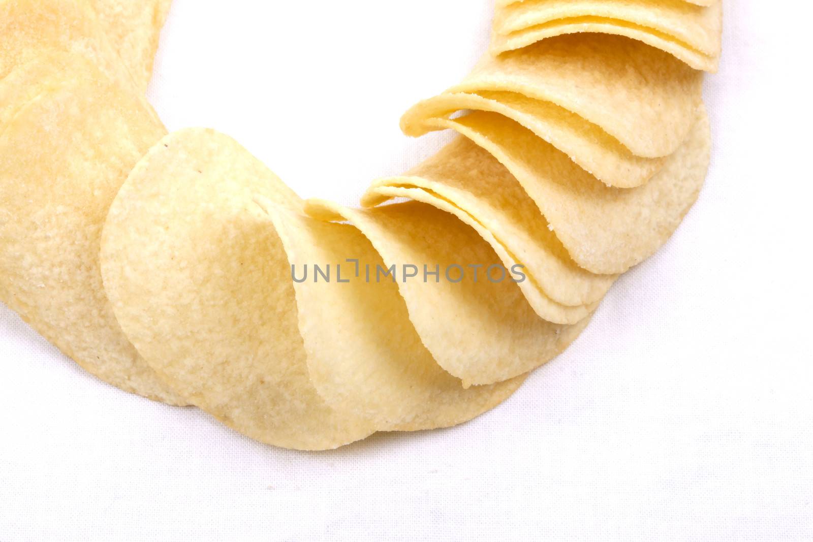 Tasty potato crisps (chips) isolated on a white background