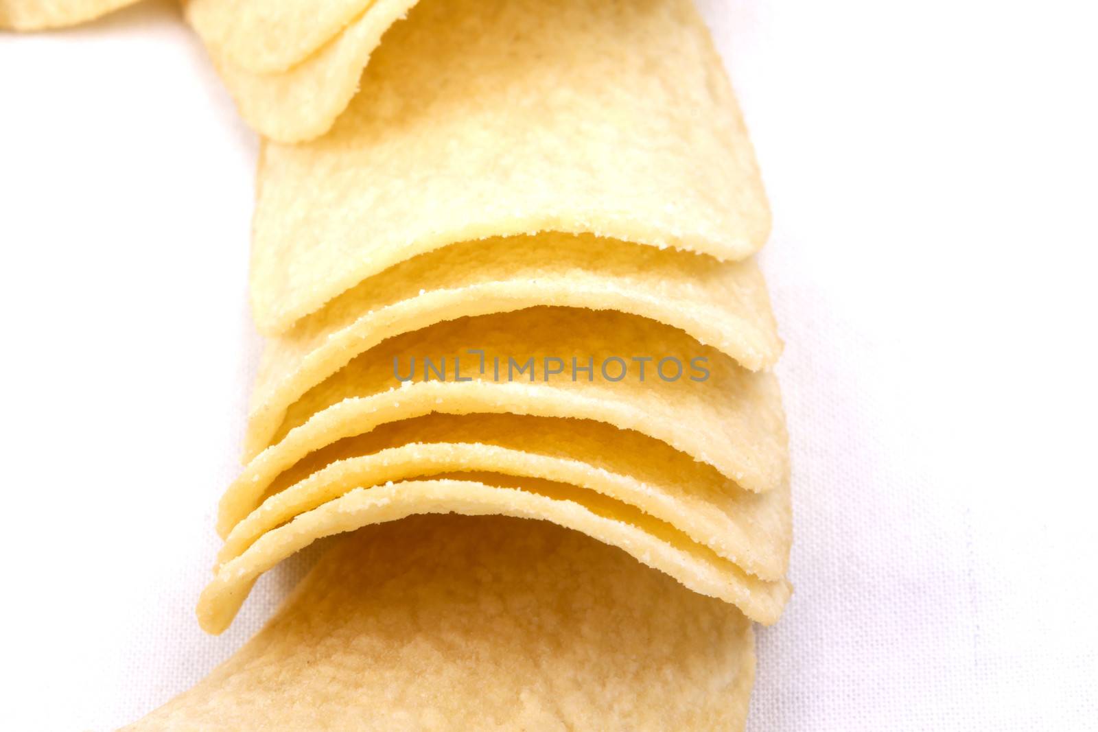 Tasty potato crisps (chips) isolated on a white background