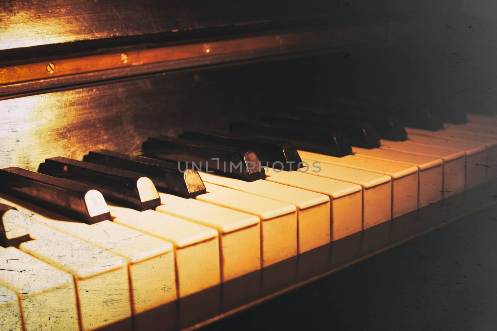 Old piano keyboard close up as a music background. With scratches and dust paper texture