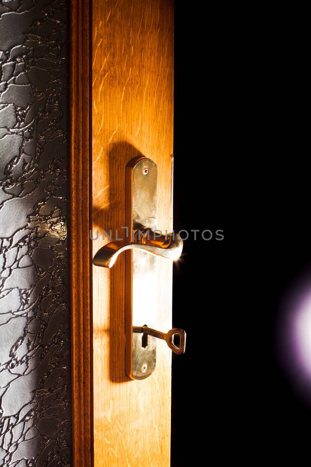 Open door with key into the dark room with light