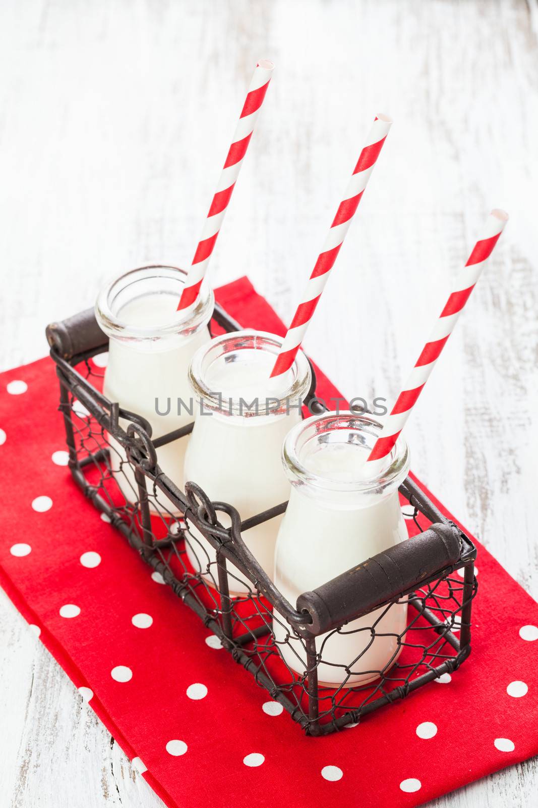 Milk in bottles with paper straws for children