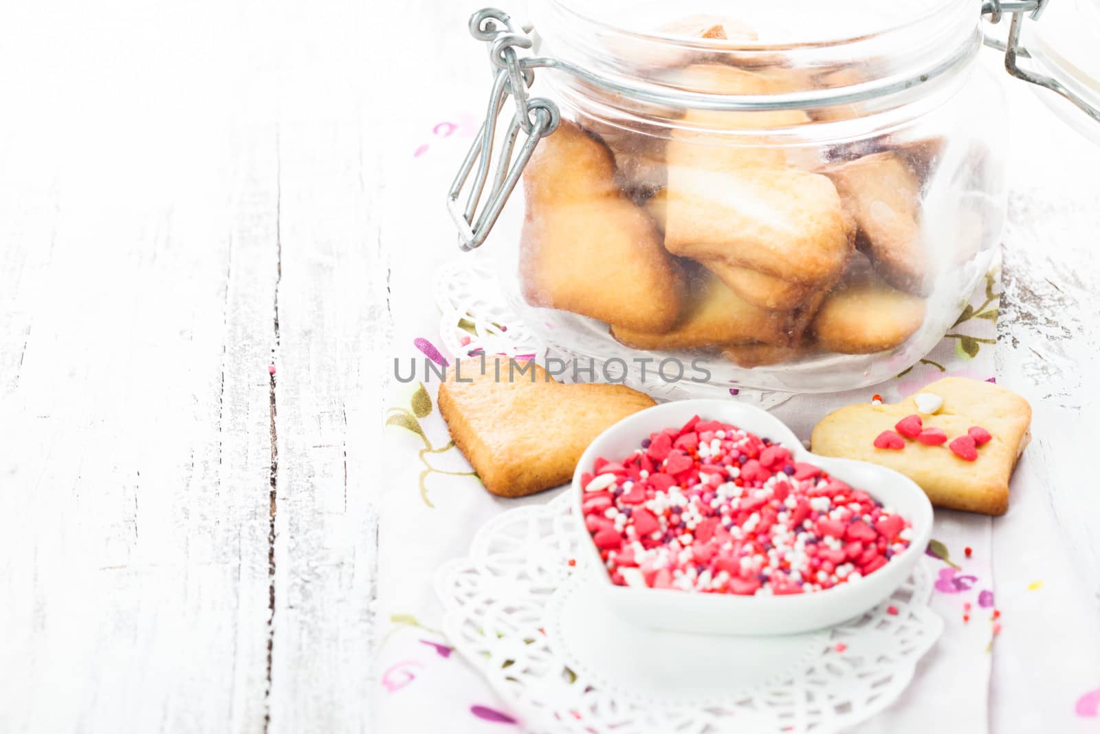 Cookie as a heart shaped valentine decor in glass jar on the table