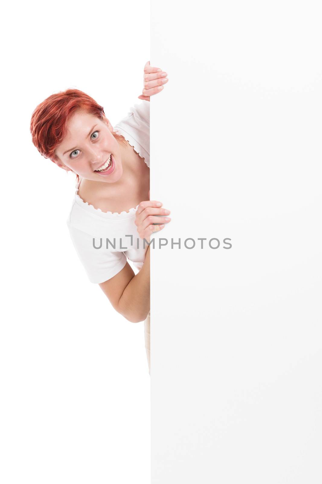 young woman looking excited from behind a white board