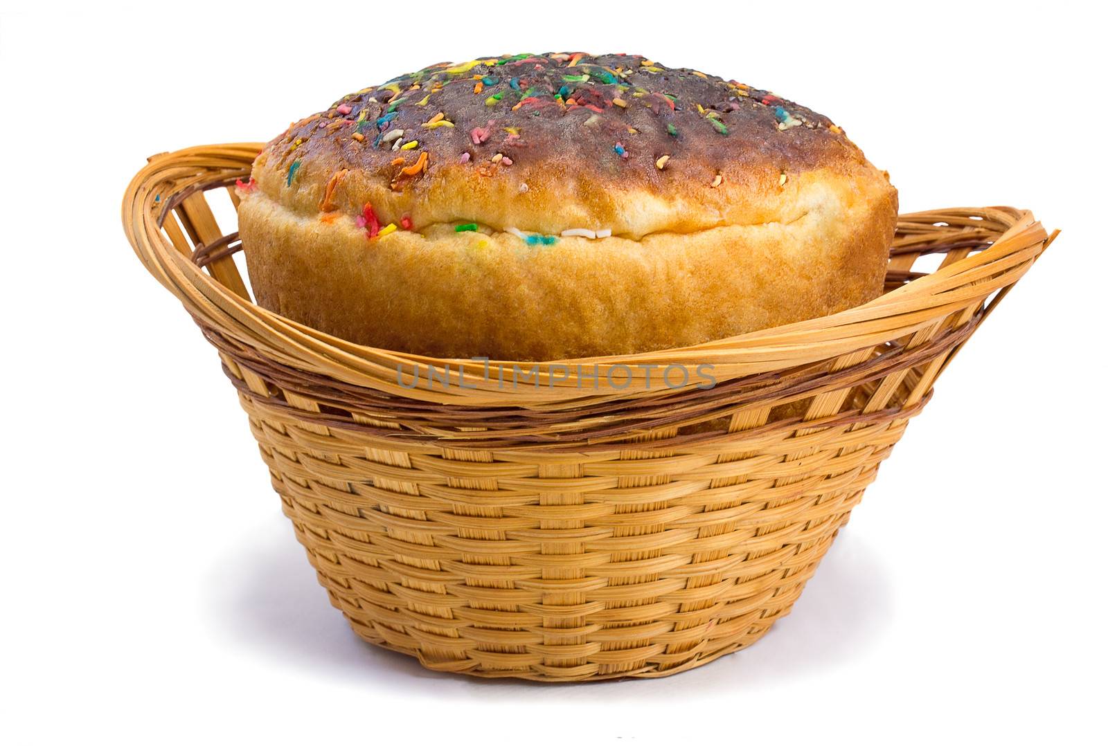 Beautifully decorated Easter bread in a wicker basket. Presented on a white background.