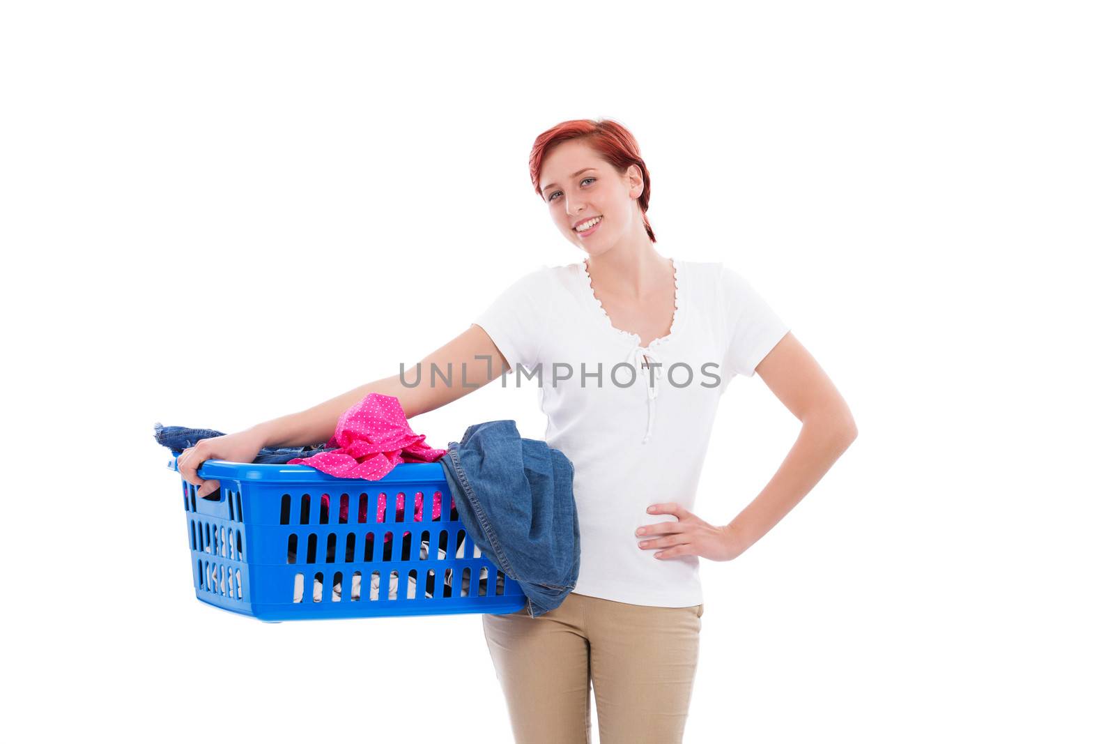 happy redhead woman with her laundry in a blue basket