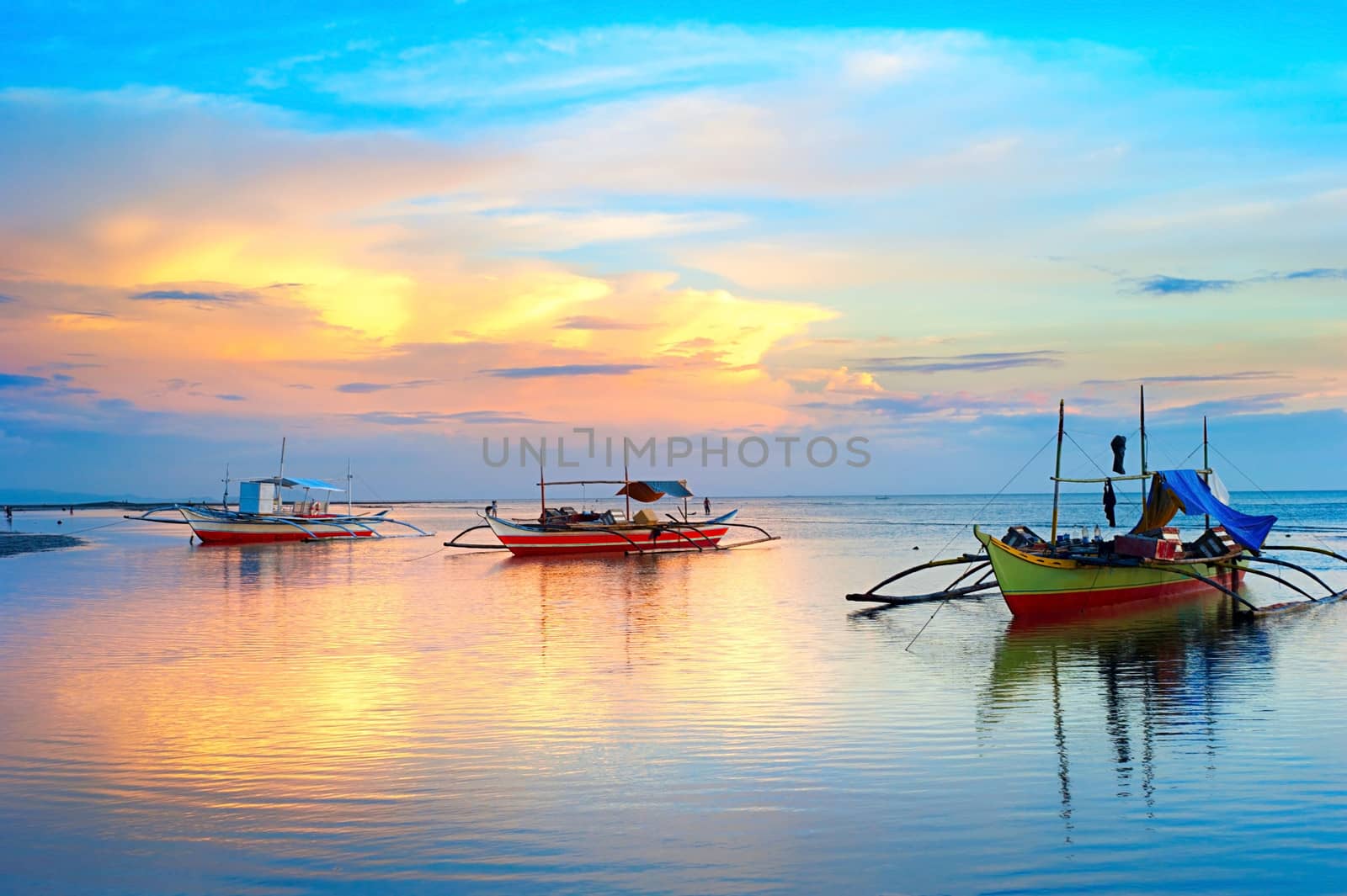 Landscape with traditional Philippines boats at sunset