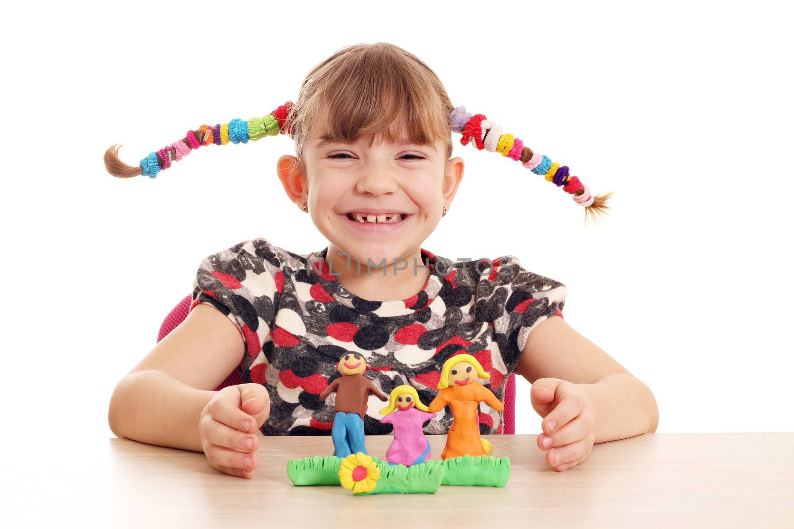 happy little girl make family figure with plasticine