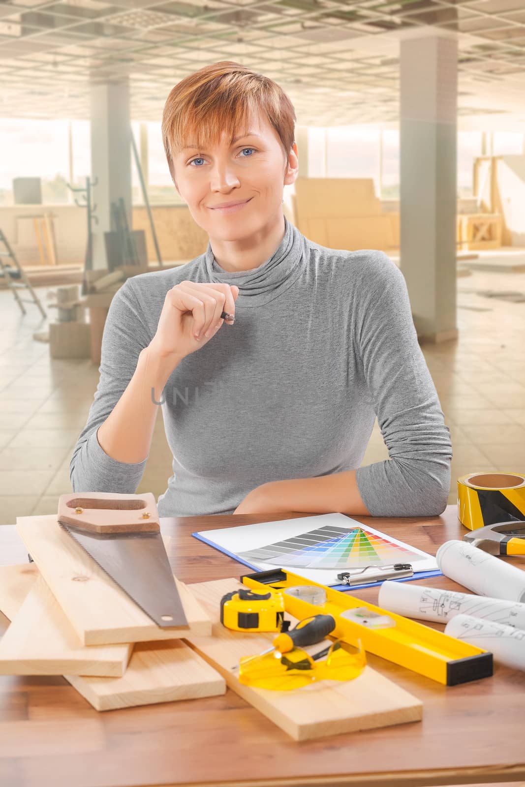 female worker sitting at table with tools