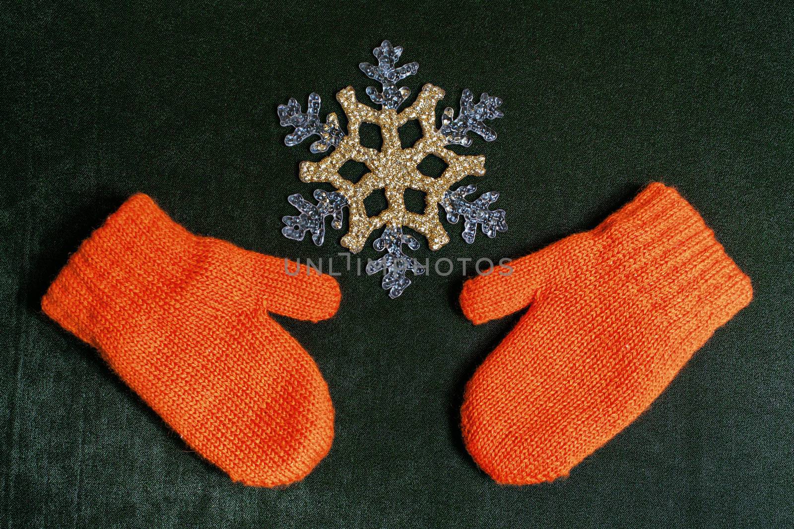 Mittens and snowflake on a textile backing christmas background close up shot