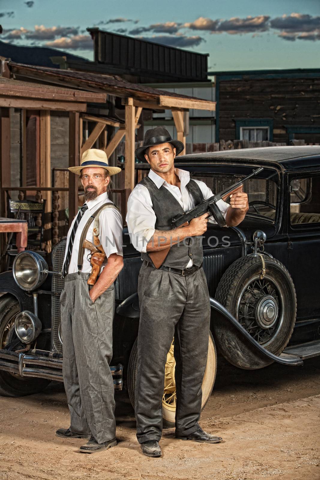 1920s era criminal partners with guns outdoors