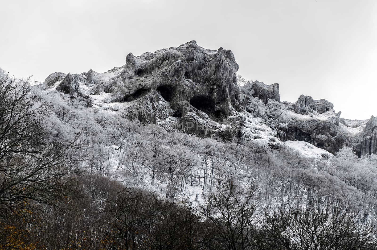 Beautiful winter picture at the rocks on the mountain. They are covered with snow and ice.