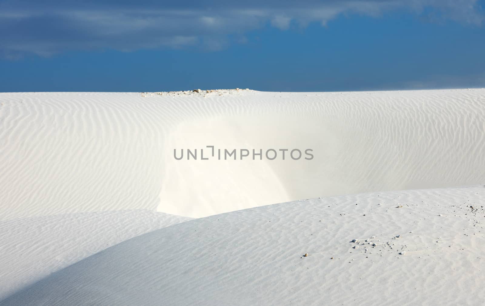 Desert scenery with white quartz sand and blue sky