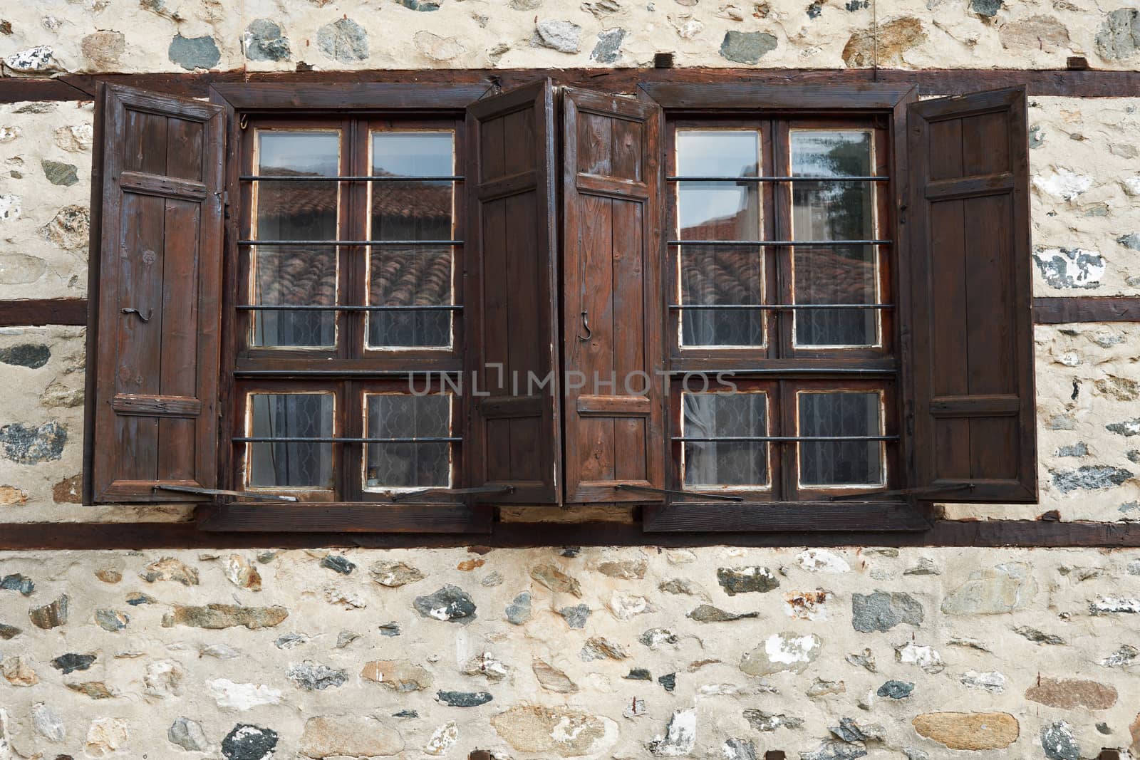 Windows of ancient stone house in Zlatograd town, Bulgaria