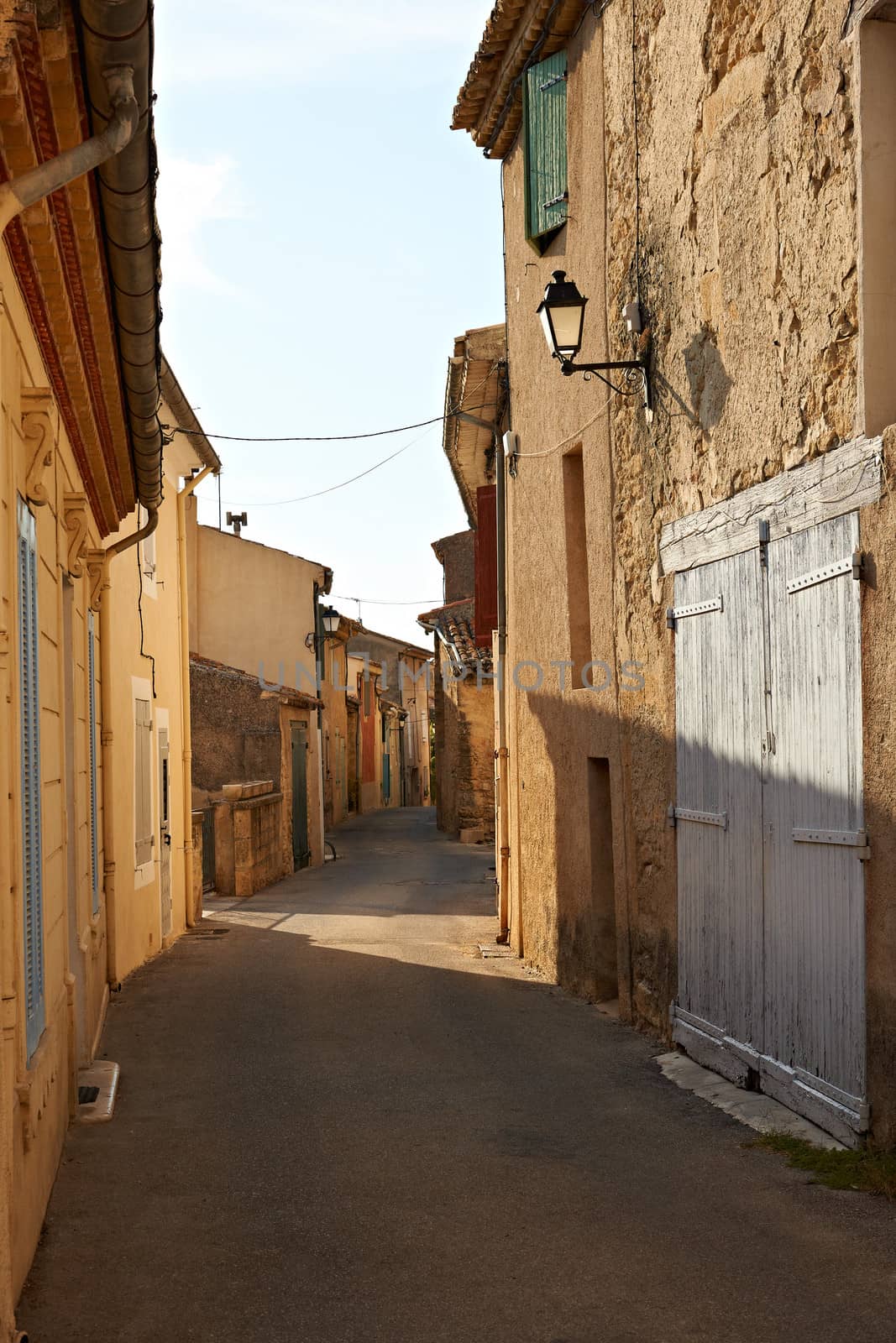 Narrow street with typical houses in village of Ansouis, Provence, France, region Luberon