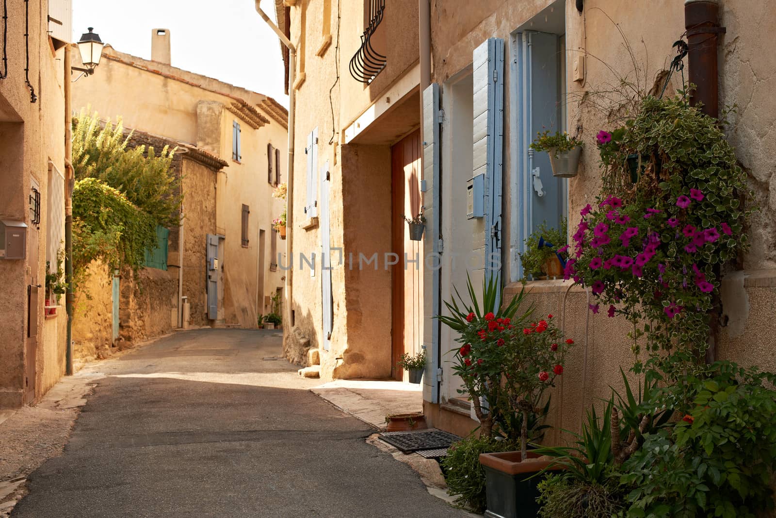 Narrow street with typical houses in village of Ansouis, Provence, France, region Luberon