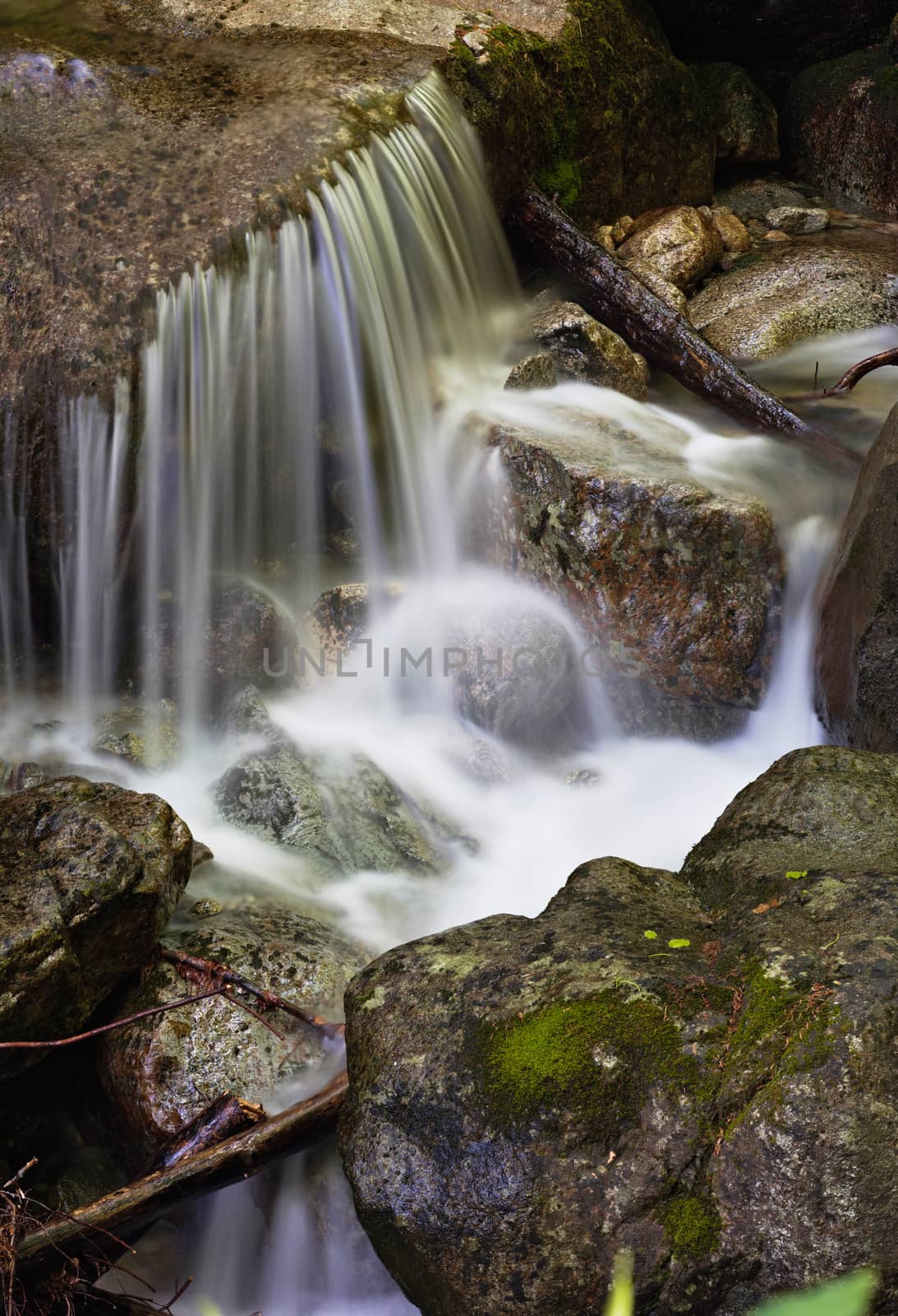 Water of a mountain stream current, running on stones