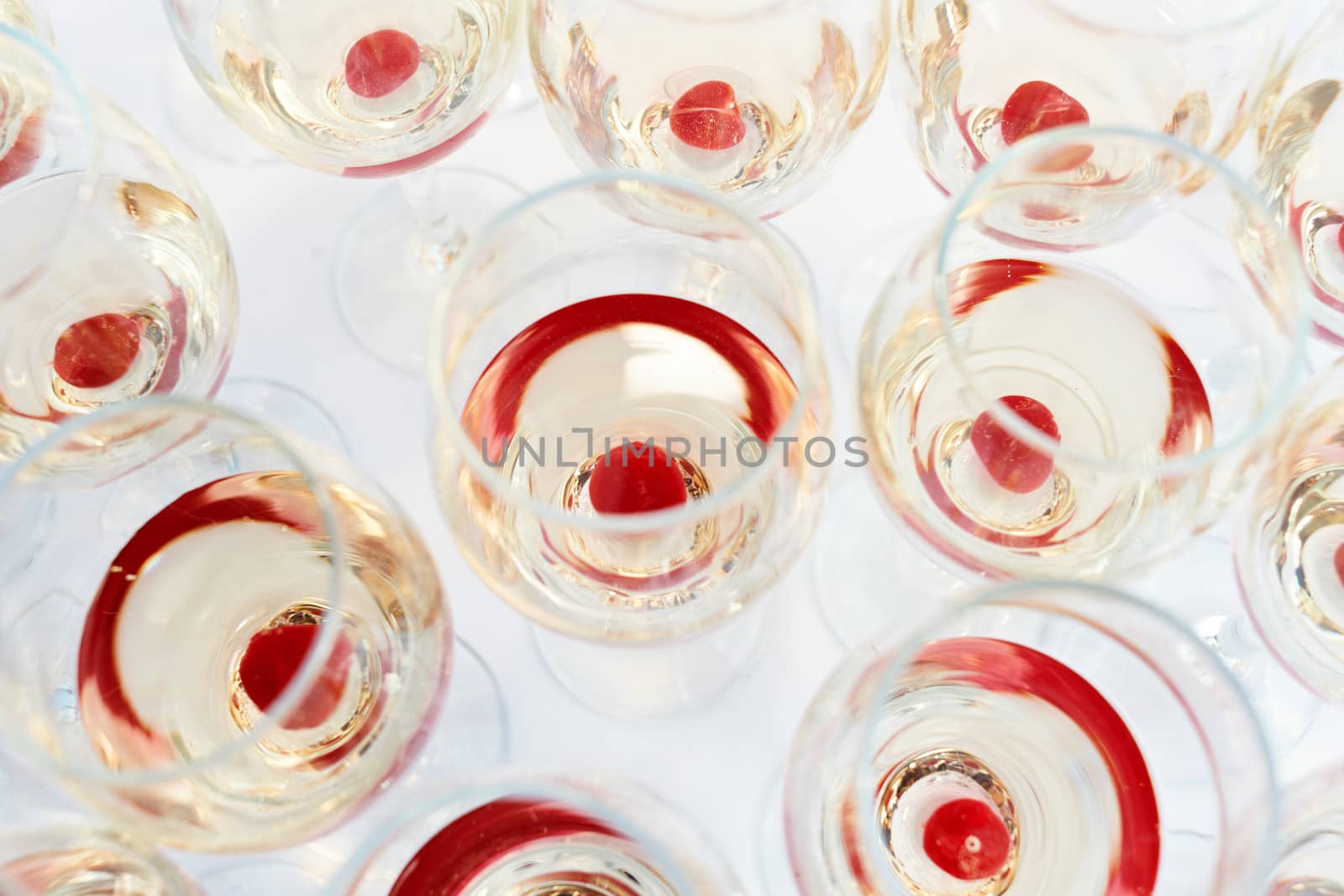 Multiple party glasses with red cherry drink on table