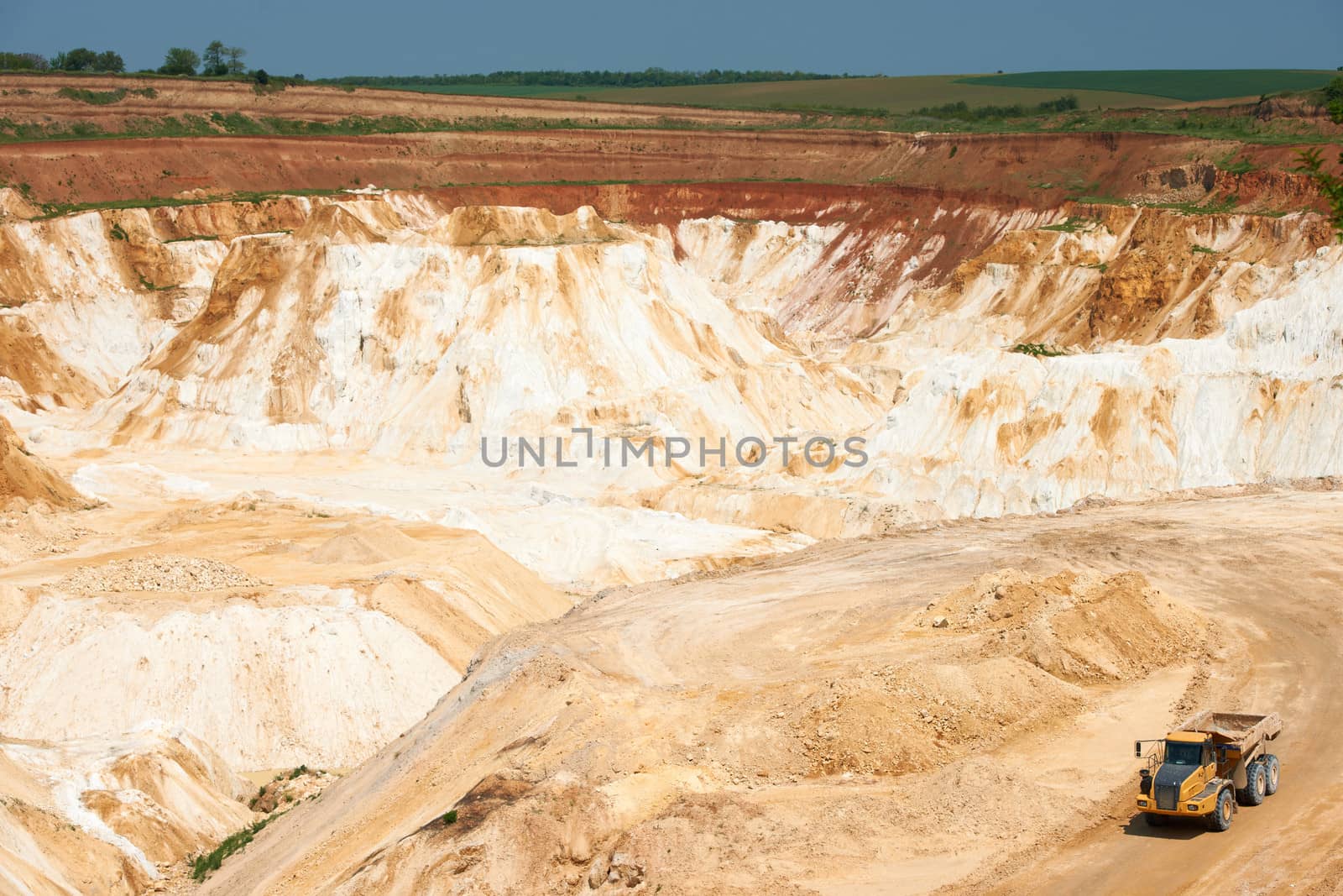 Limestone quarry with white material and truck