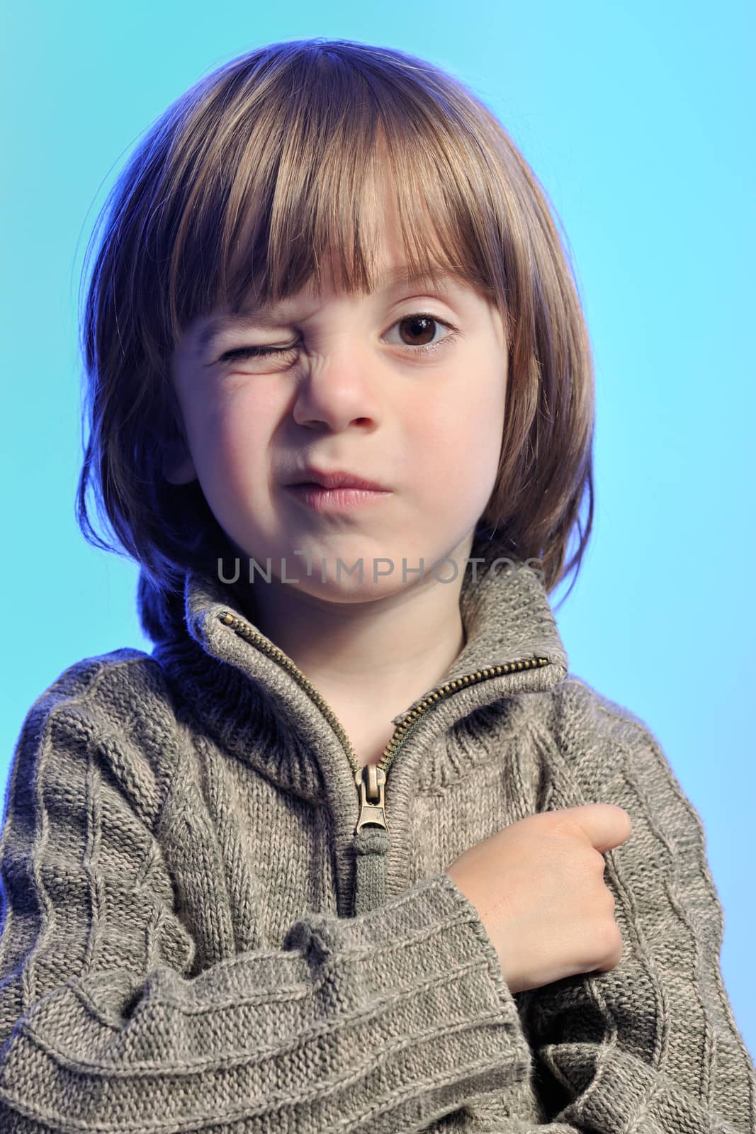 Little cute boy giving a wink to camera man