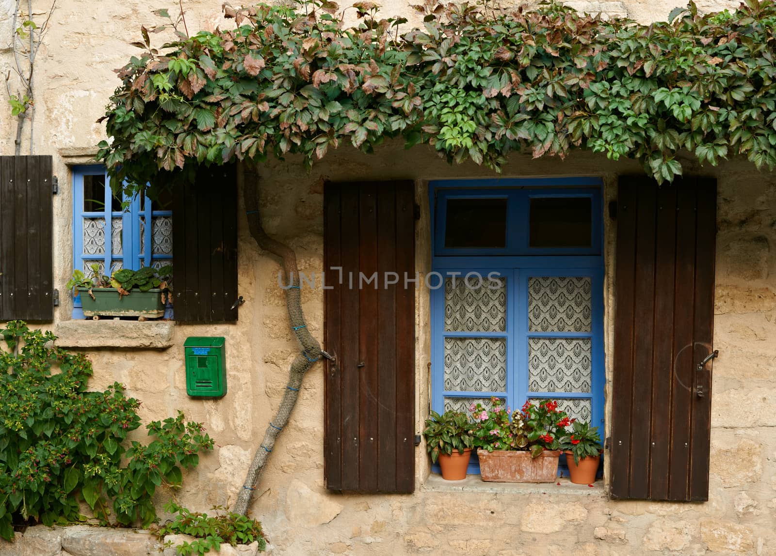 Windows od old traditional house in village of Cucuron, French Provence