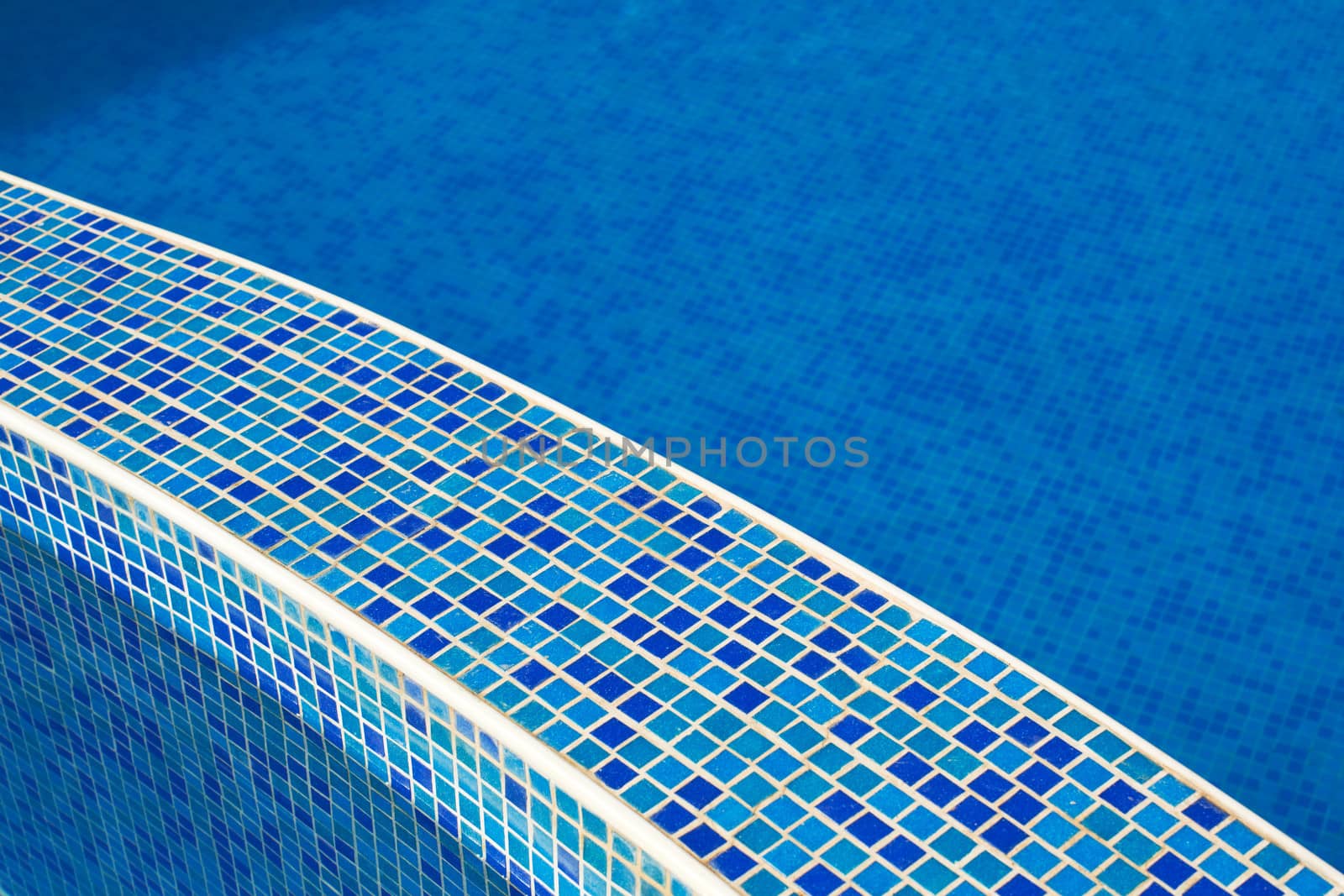 Blue water in a pool with tiles