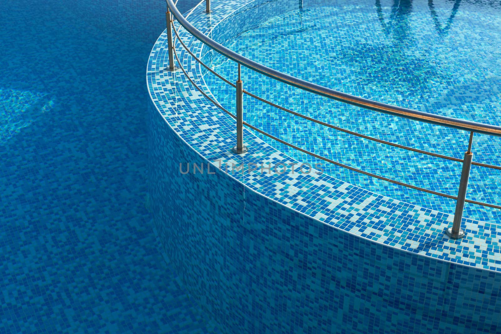 Blue water in a pool with tiles