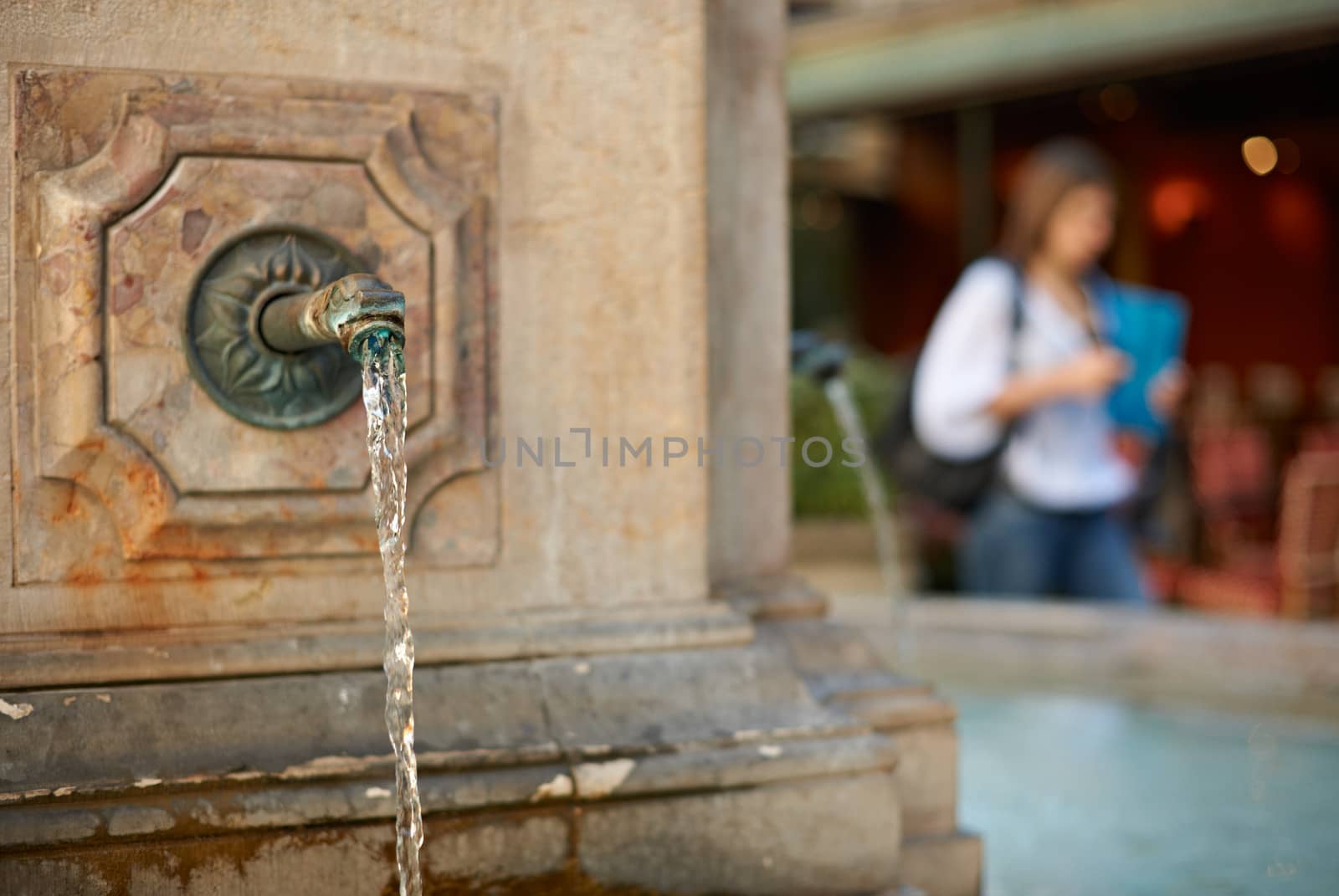 Fresh water fountain in Aix en Provence and a woman silhuette