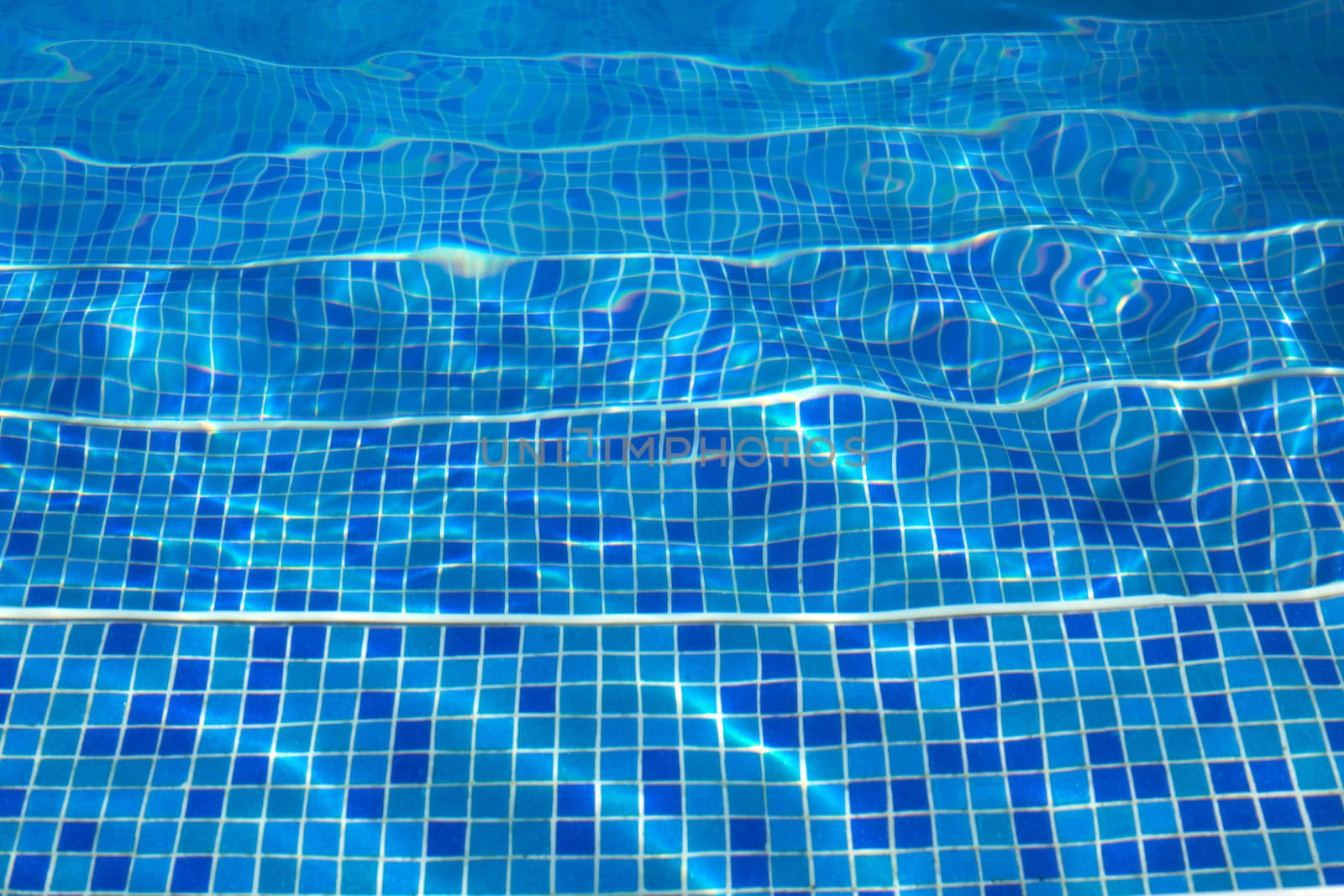 Blue tiles of a swimming pool stairs