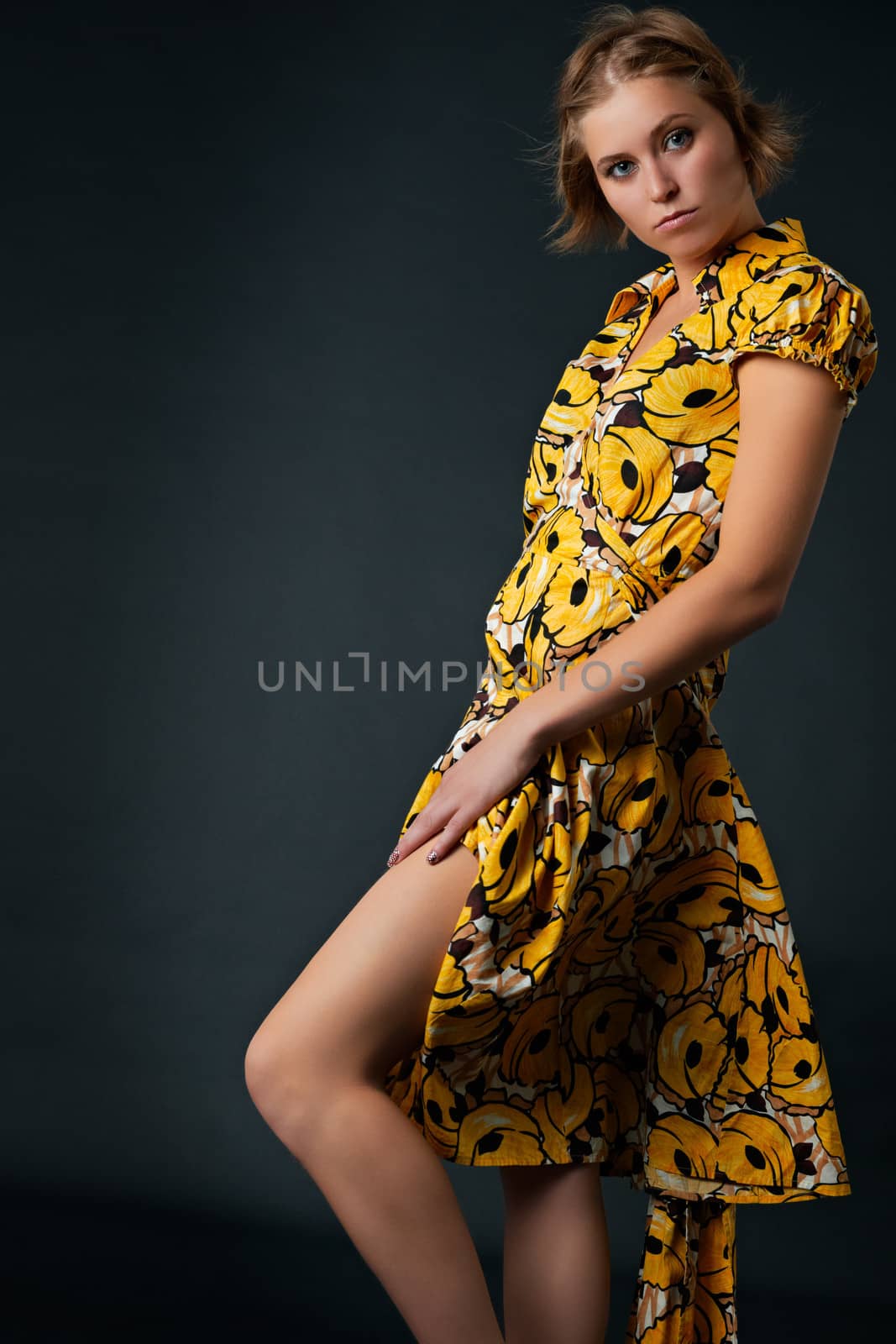 Young temptating girl in yellow dress