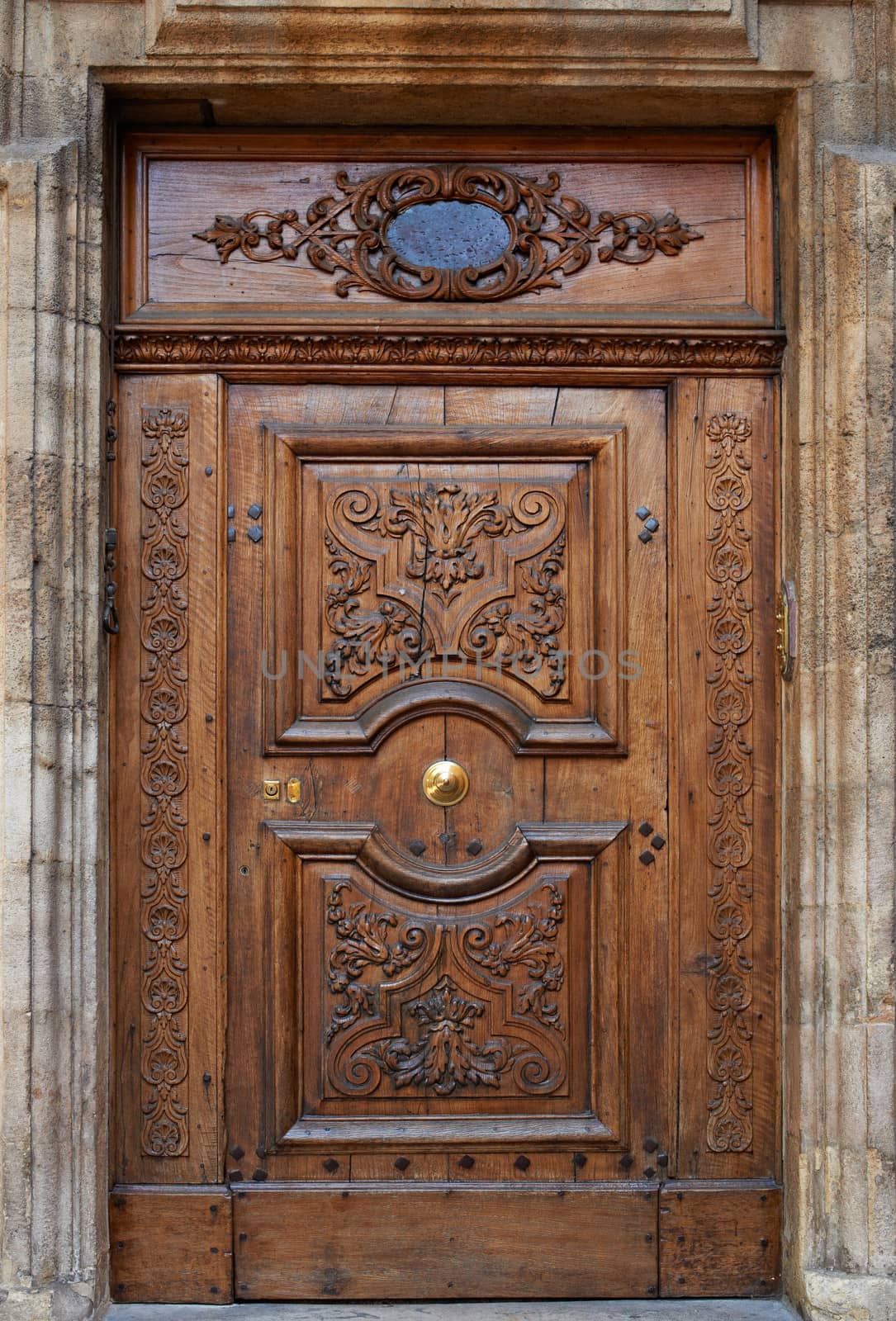 Old wooden gate with beautiful carvings in Aix en Provence, France