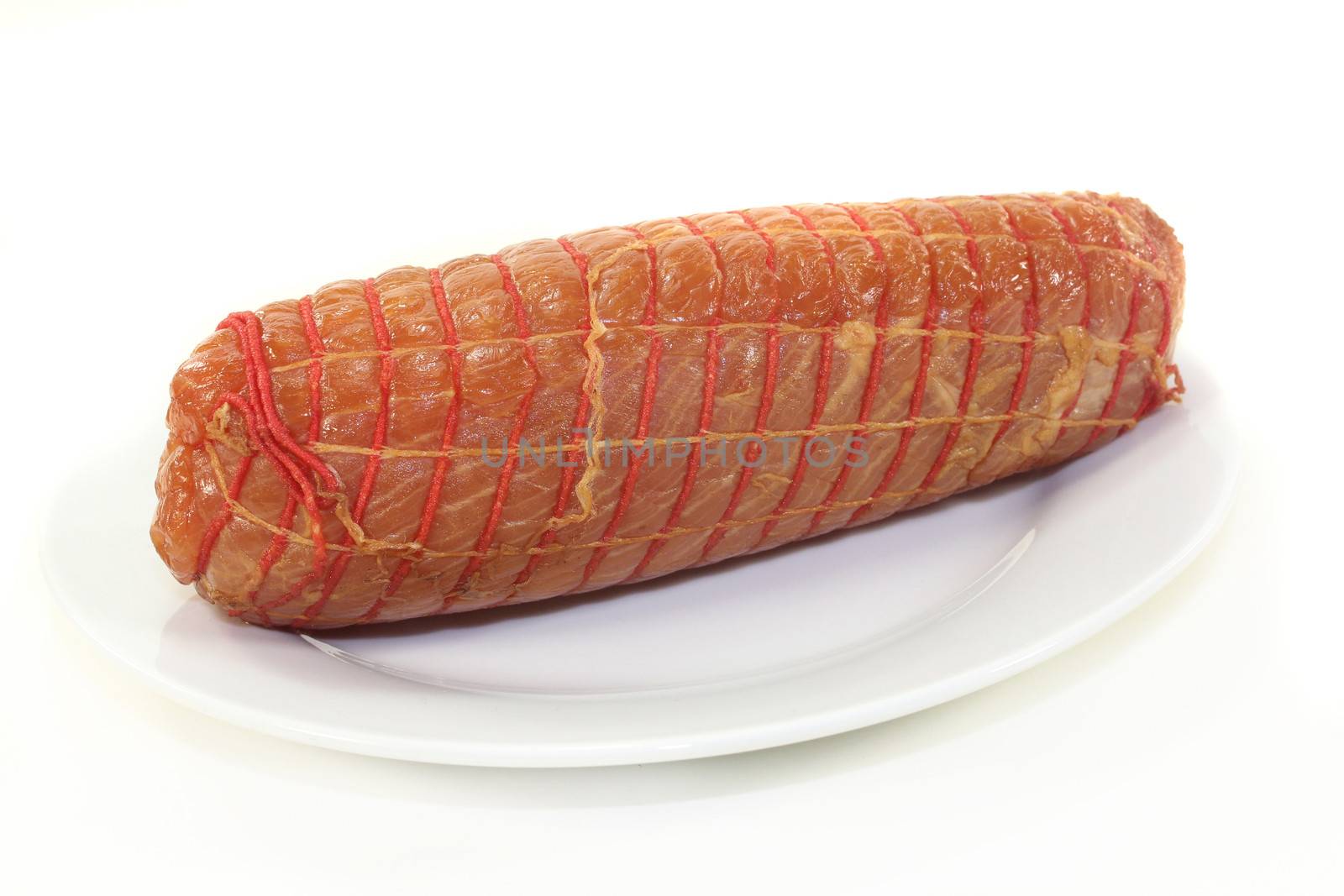 a piece of turkey fillet of salmon in front of white background