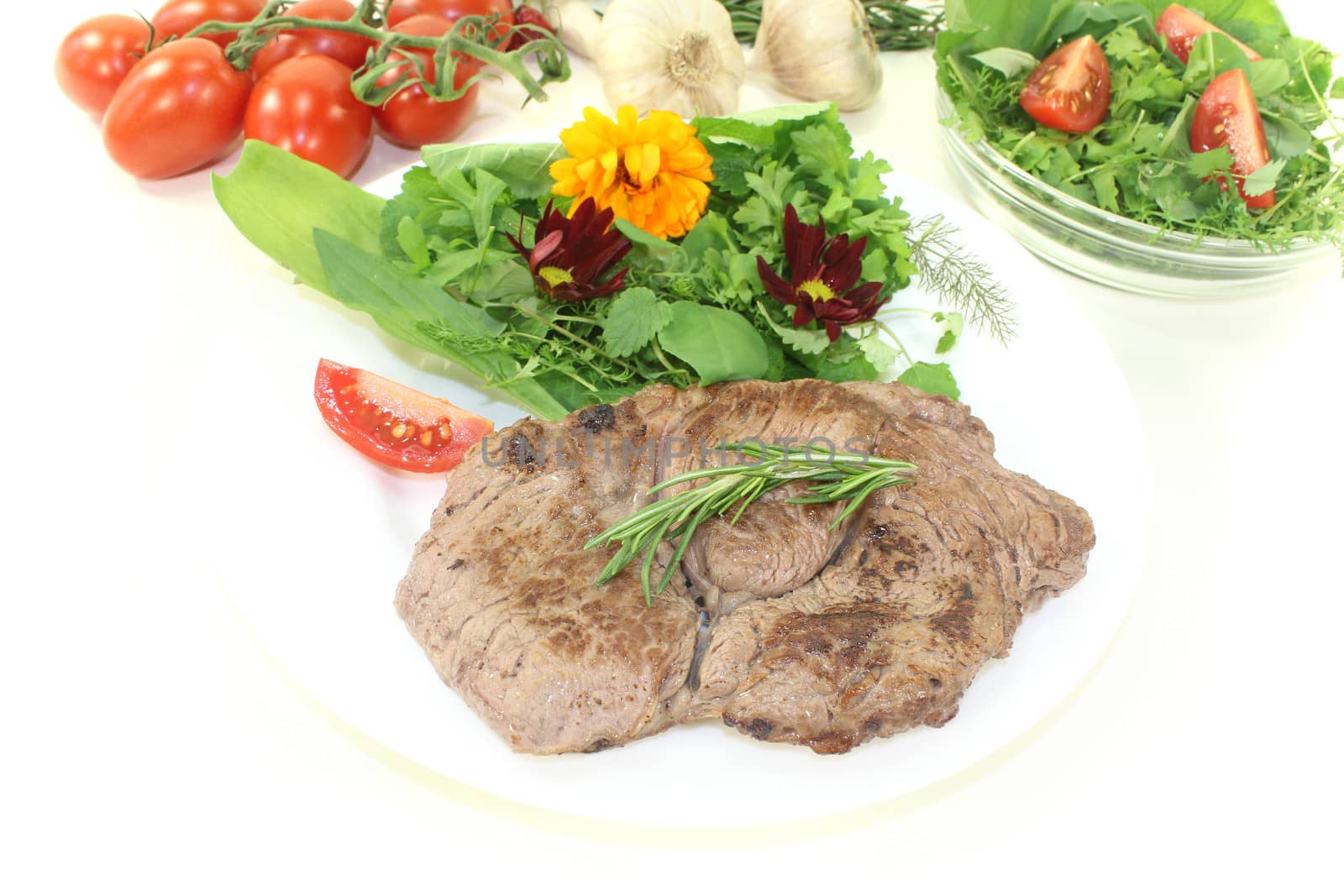 Sirloin steak with wild herb salad on a light background