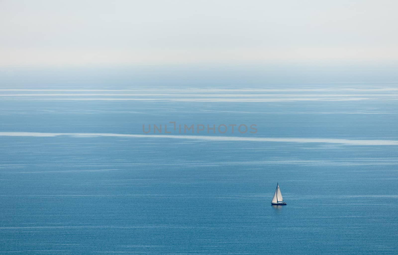 Blue sea water with a lonely boat