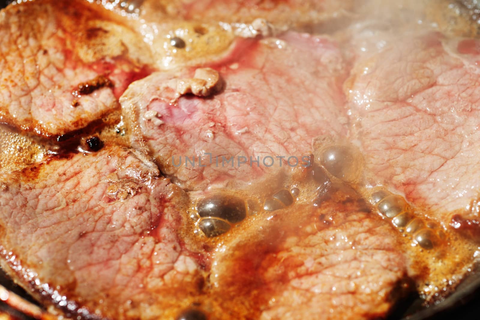 Fryed veal fillet in a frying pan