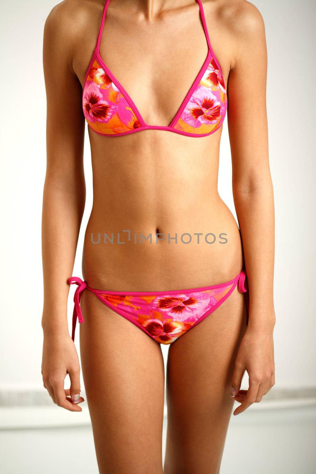 Young girl body in purple bikini swinsuit