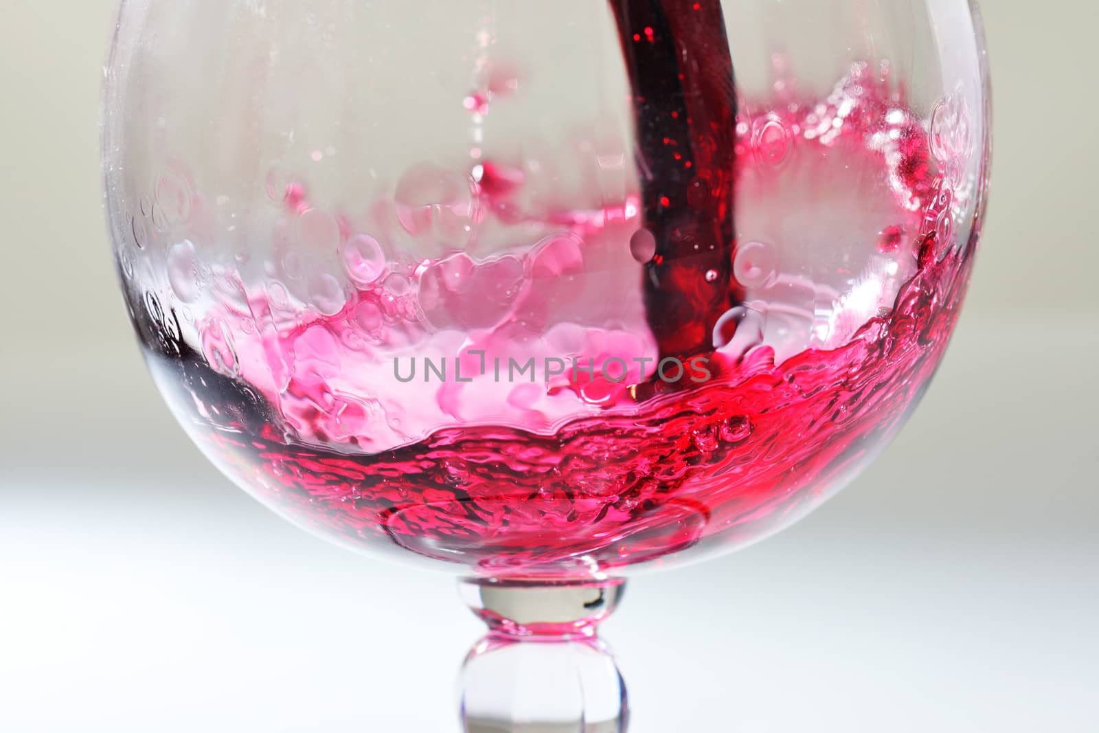 Splash of red wine in a glass