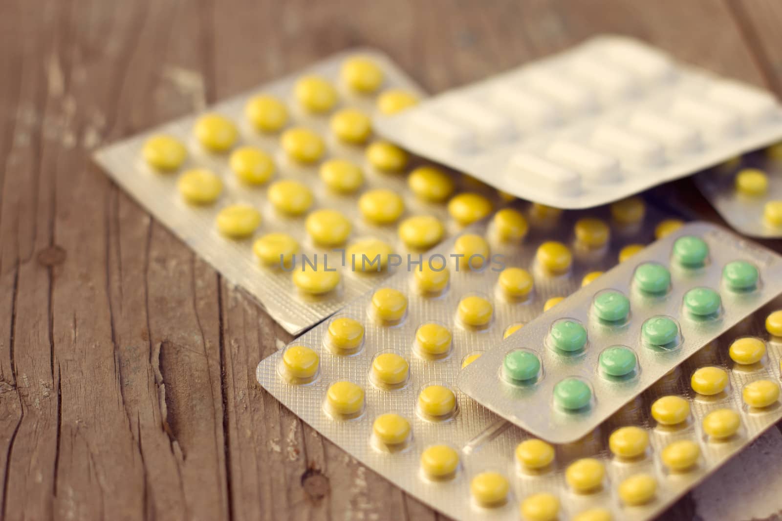 Pills, syringe and other medicine on table