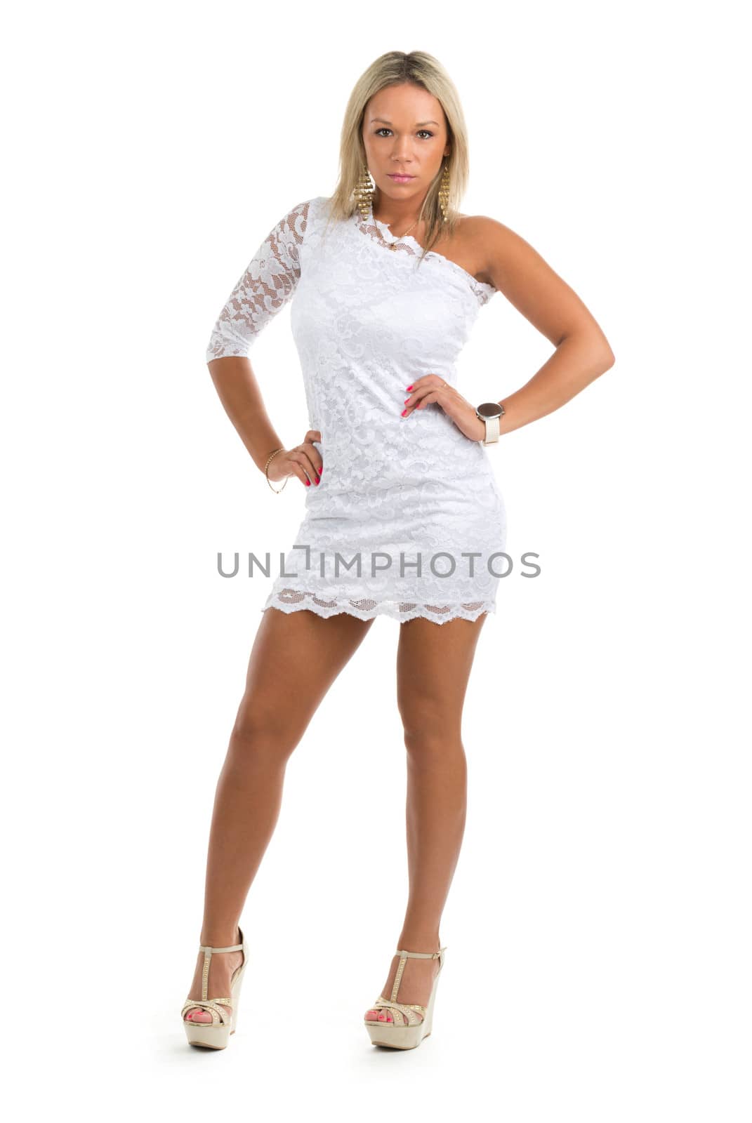 Beautiful girl in a white mini dress. Studio portrait