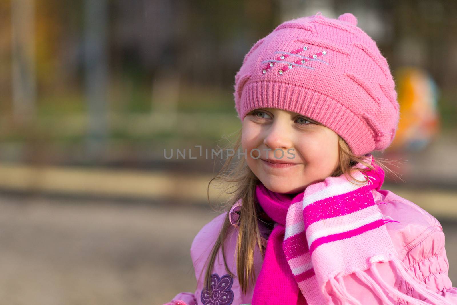 portrait of a pensive little girl in a pink hat