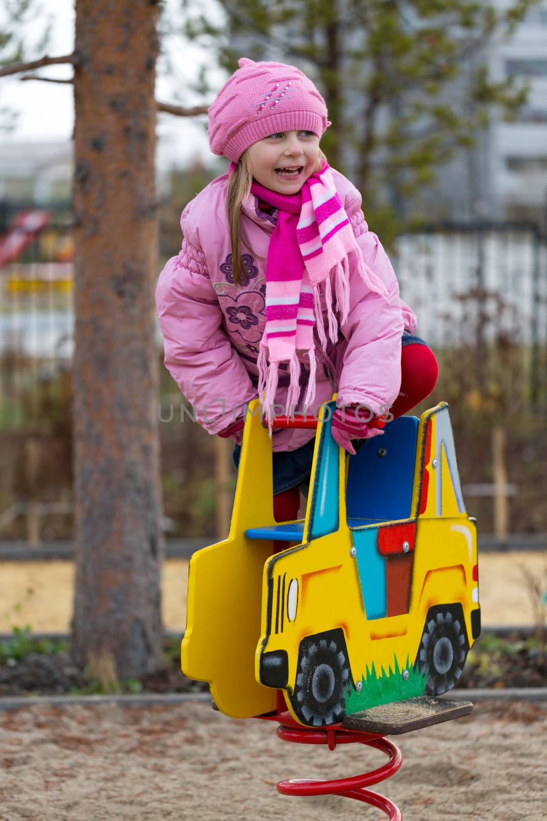 Little girl on the carousel in the autumn by RuslanOmega