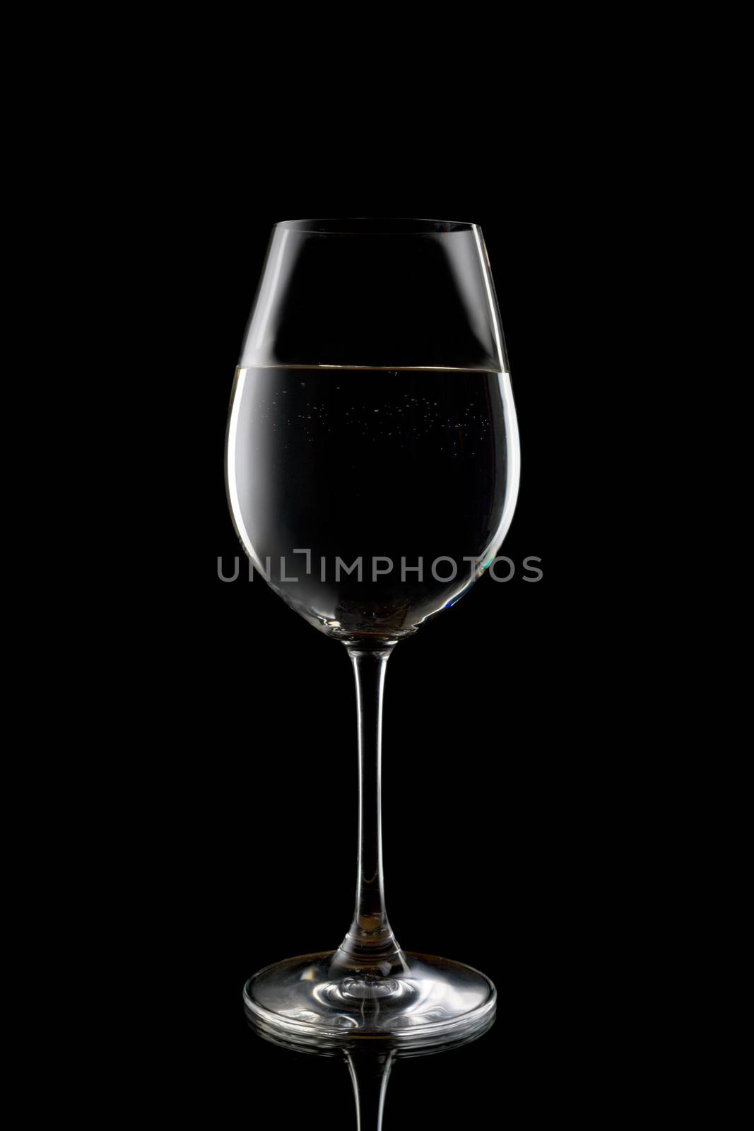 Silhouette of a wine glass with liquid. Isolate on black.