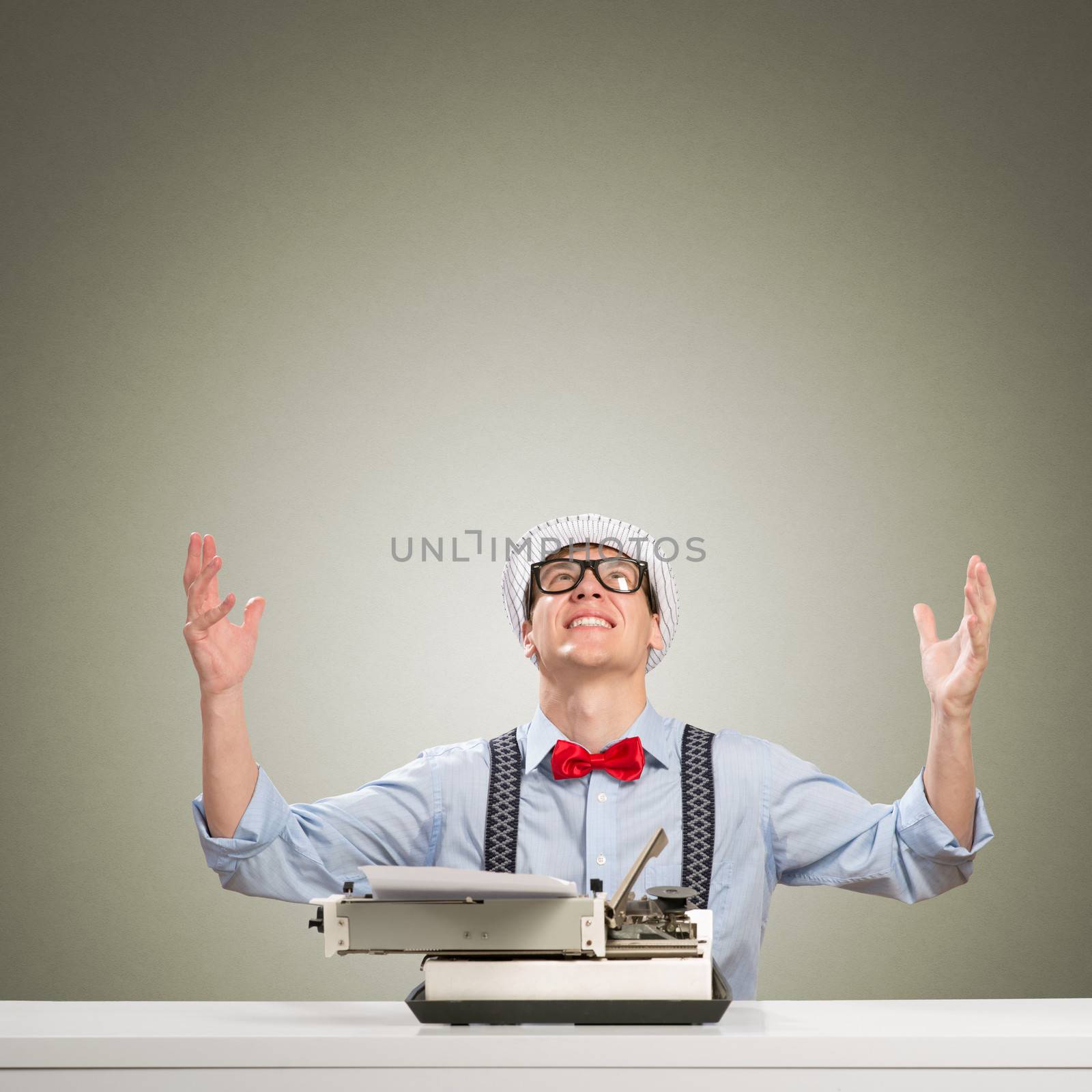 image of a young journalist, sitting at the table for a typewriter