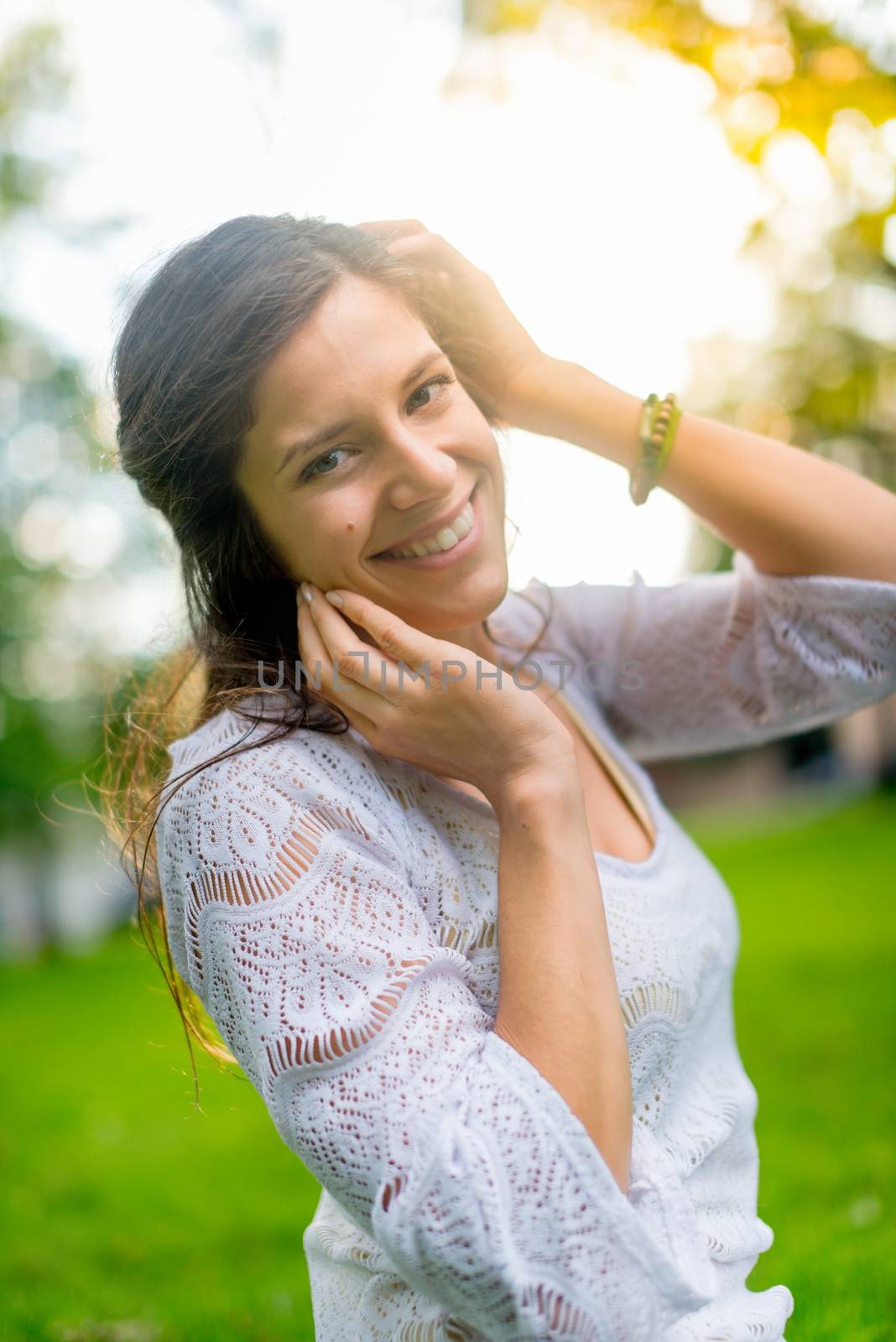 Beautiful woman enjoying the light of a summer sunset