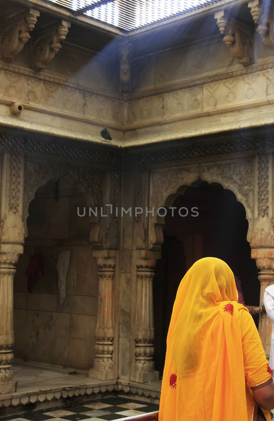 Young woman standing inside Karni Mata Temple, Deshnok, India by donya_nedomam