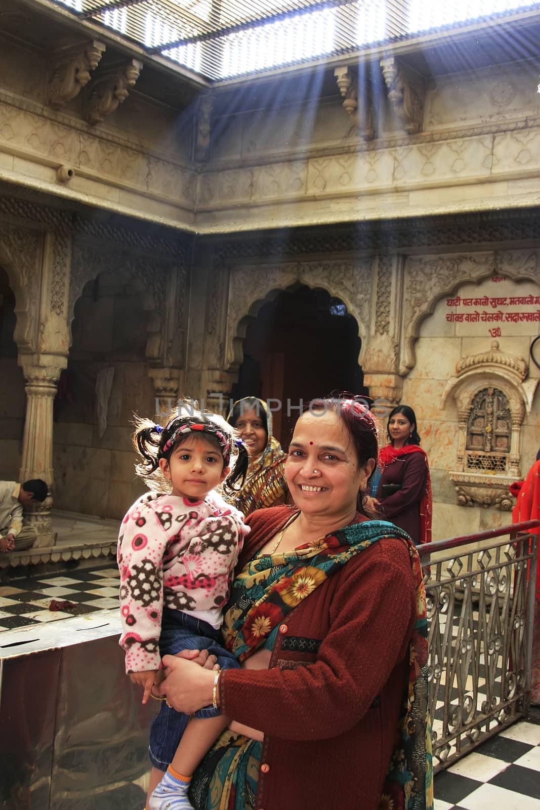 Indian woman with a girl standing inside of Karni Mata Temple, Deshnok, Rajasthan, India