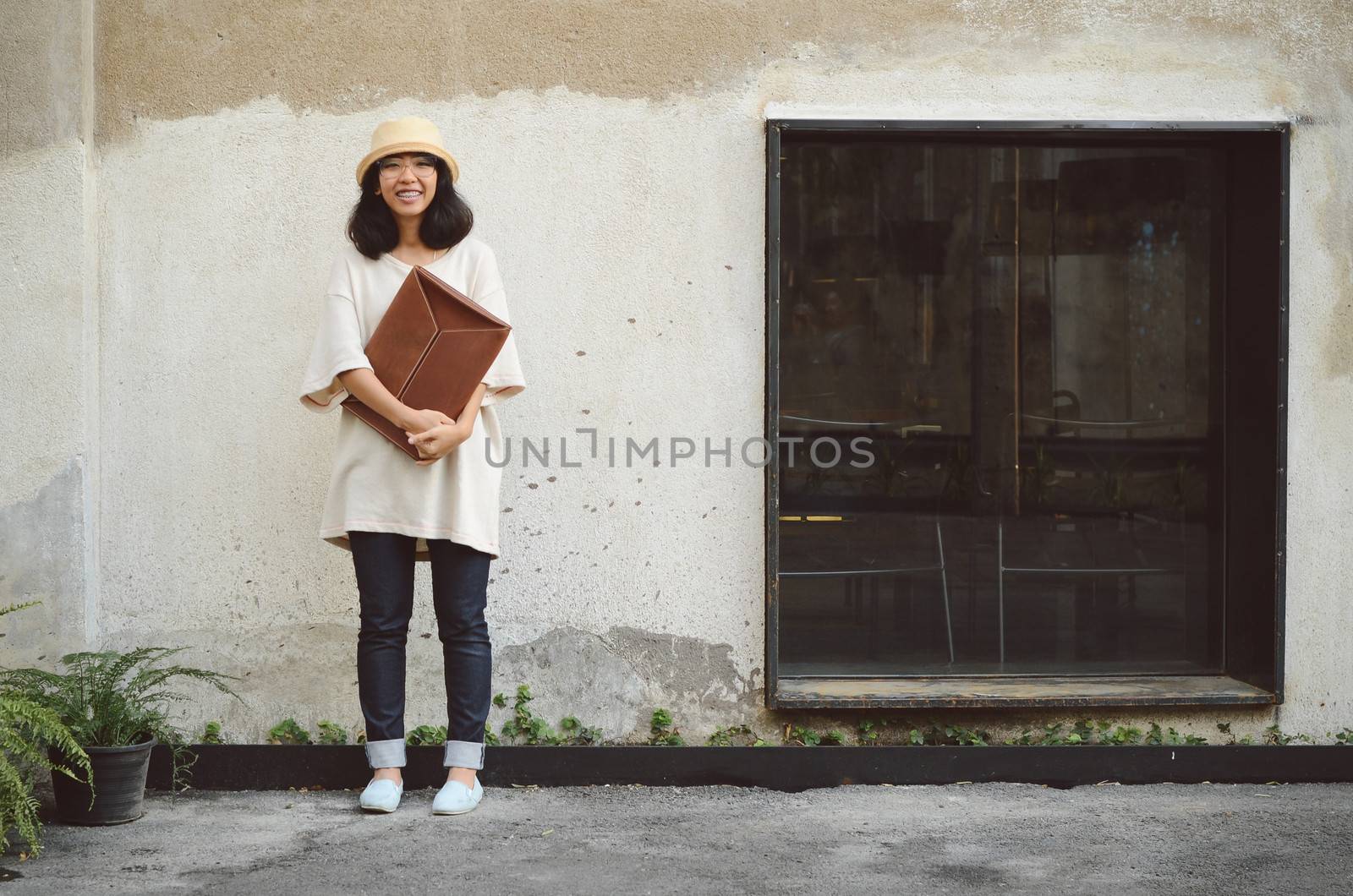 Young woman with a leather handbag by siraanamwong