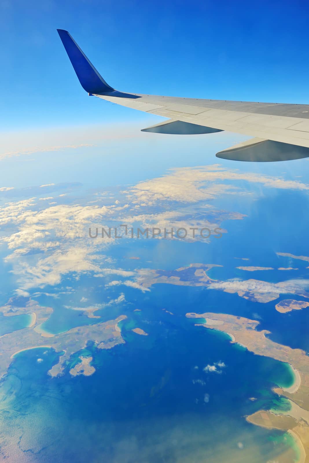 Wing of an airplane over ocean