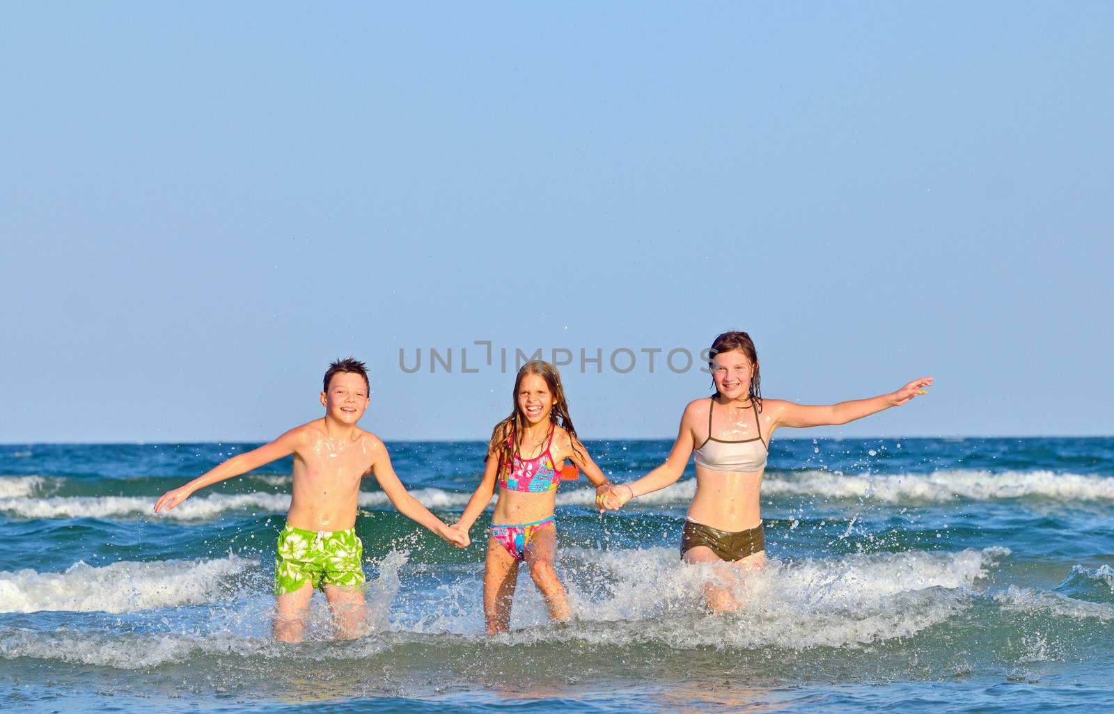 Kids splashing and playing in the sea water