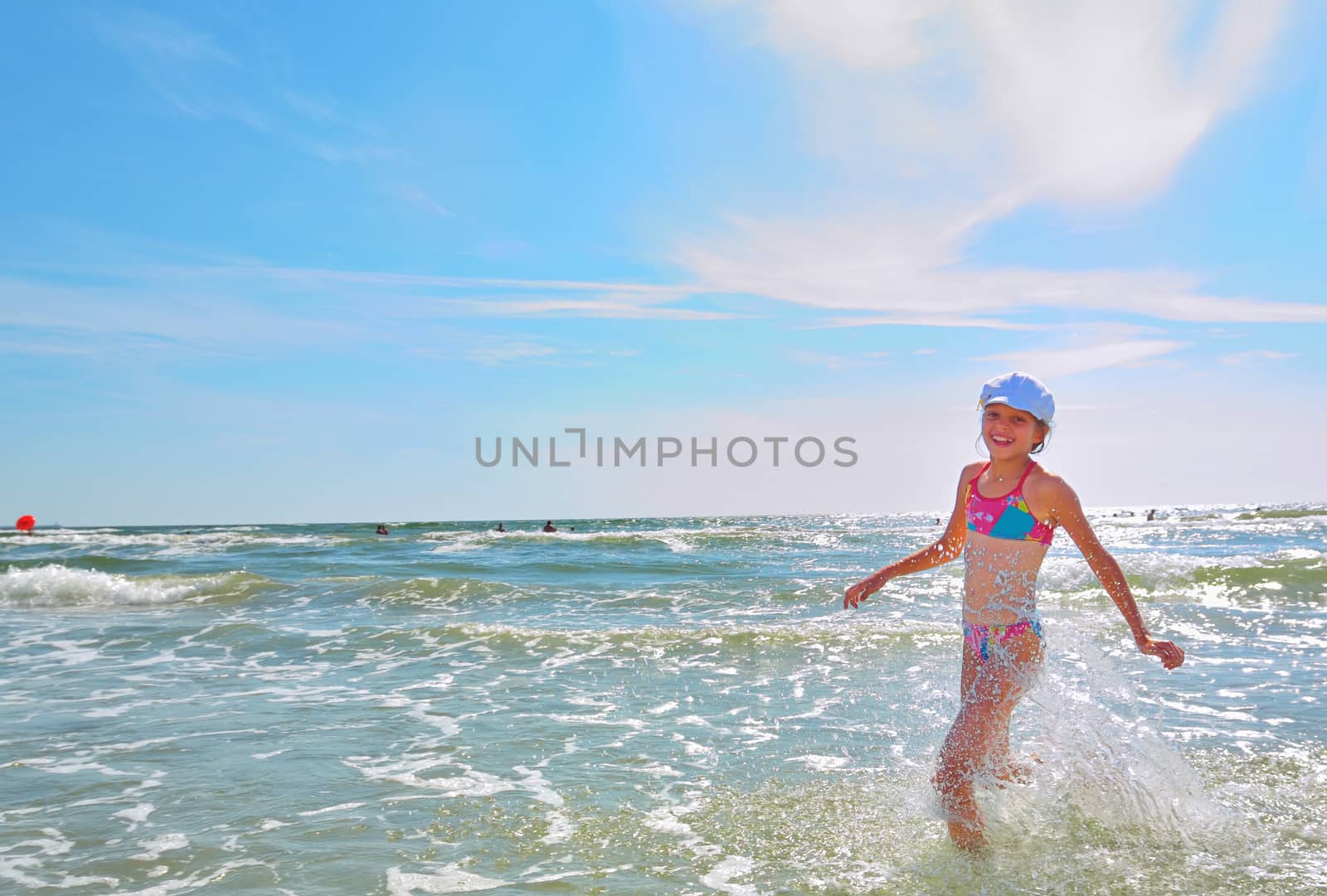 Girl running on water at sea beach